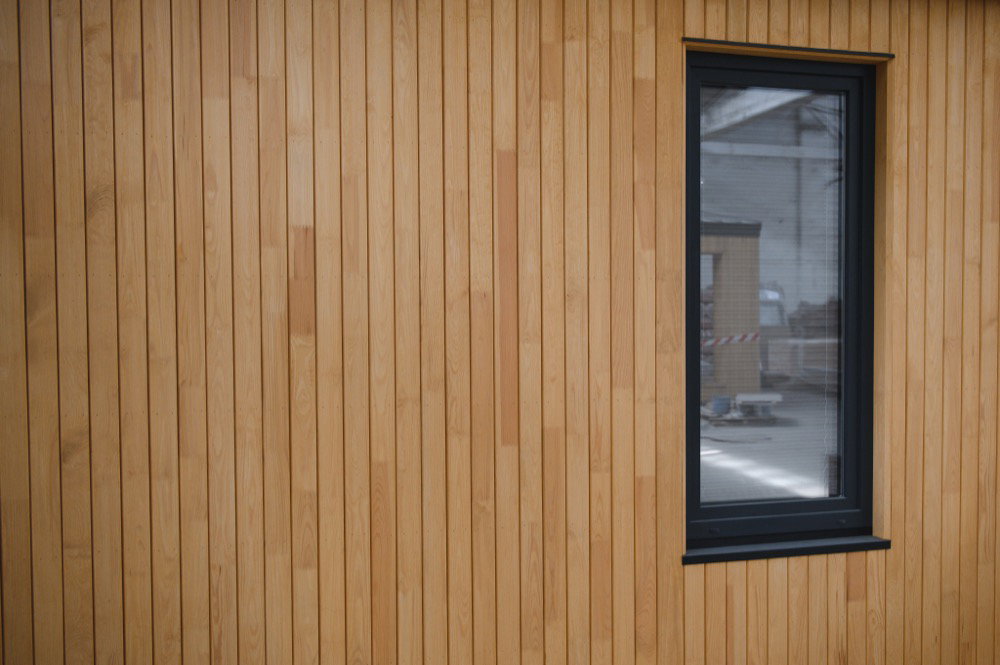 A timber weatherboard-clad building exterior with a window