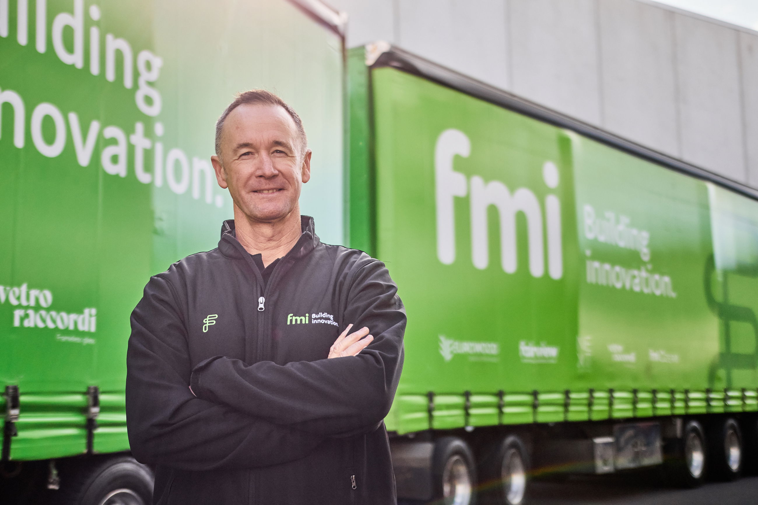 Greg Murphy - FMI Brand Ambassador - standing outside an FMI branded truck